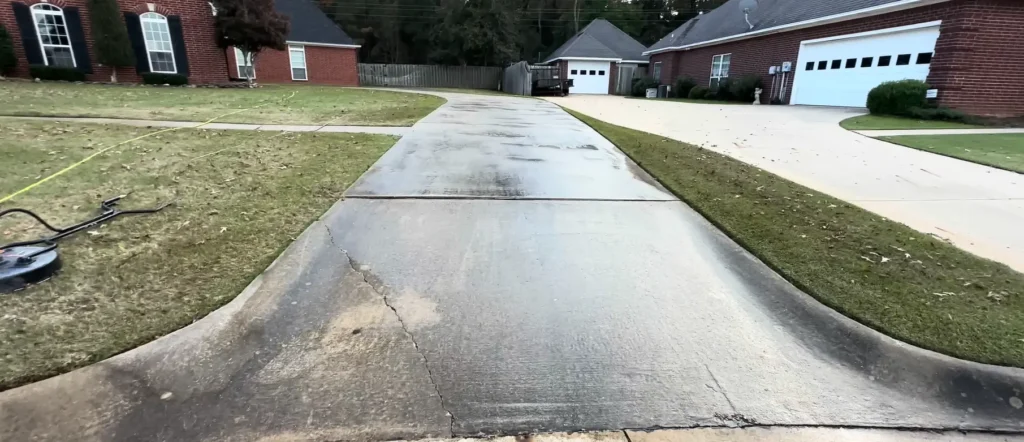 Freshly pressure washed residential driveway with cleaning equipment in Jacksonville, FL