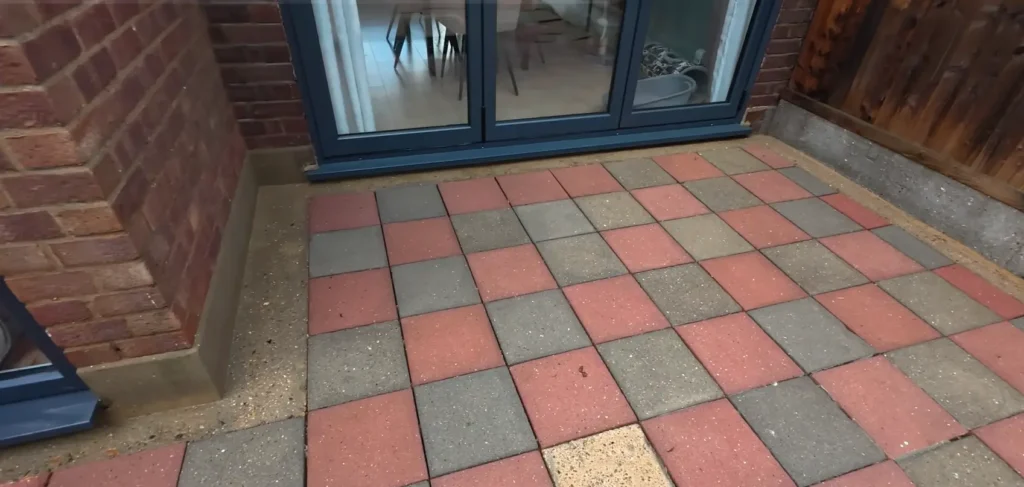 Clean paver patio tiles near glass doors after pressure washing in Jacksonville, FL